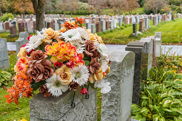 Flowers on the graves, with tombstones in the background.