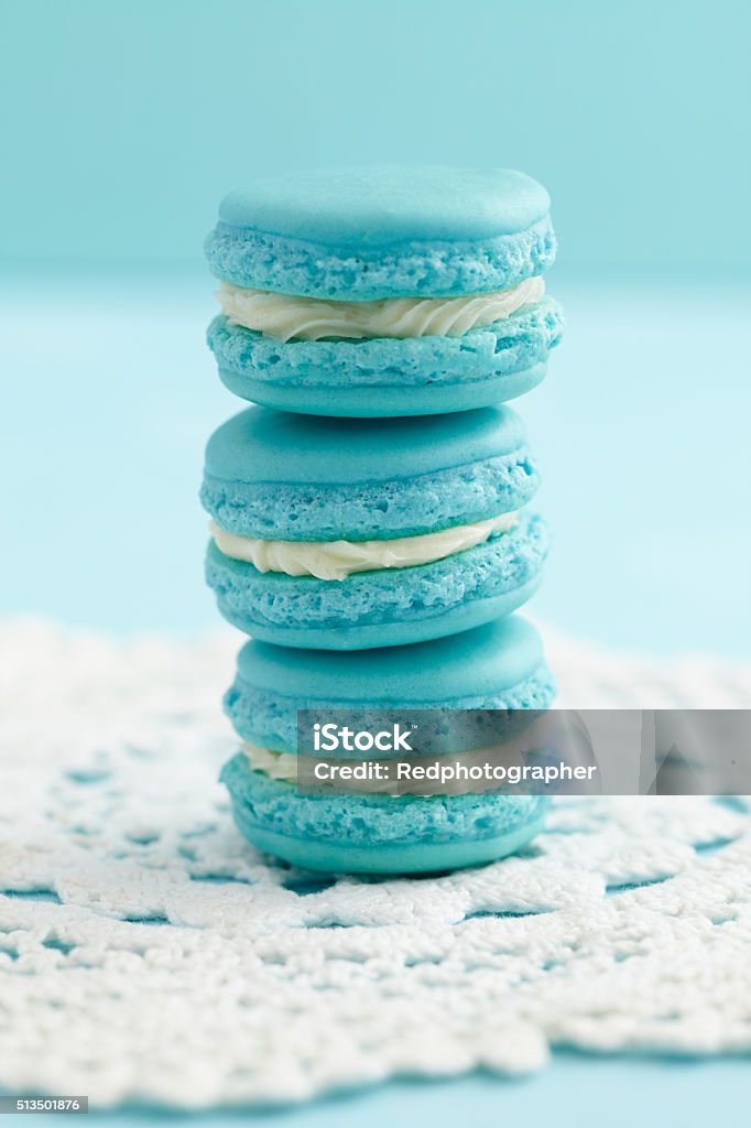 Turquoise macarons with buttercream filling Three turquoise macarons with buttercream filling on crochet cloth Almond Stock Photo