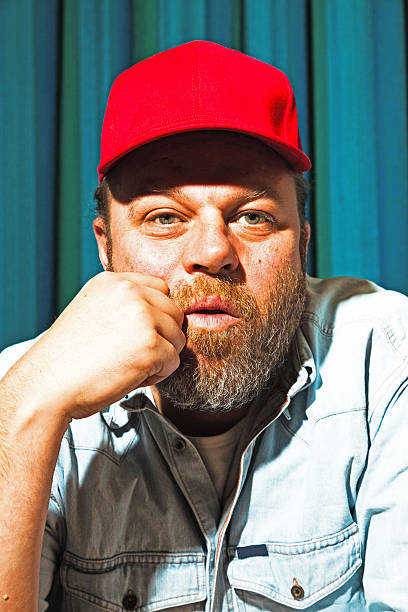 istock Man with beard and red cap. Portrait of a trucker. 513532959