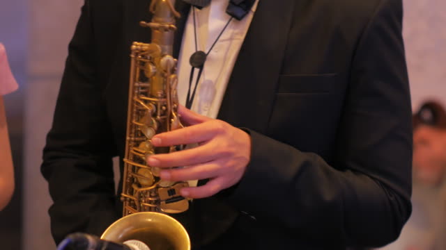 A Man plays a saxophone