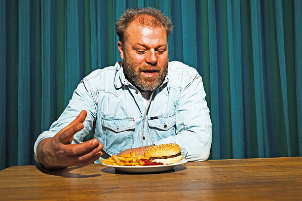 istock Man with beard eating fast food meal. 513533801