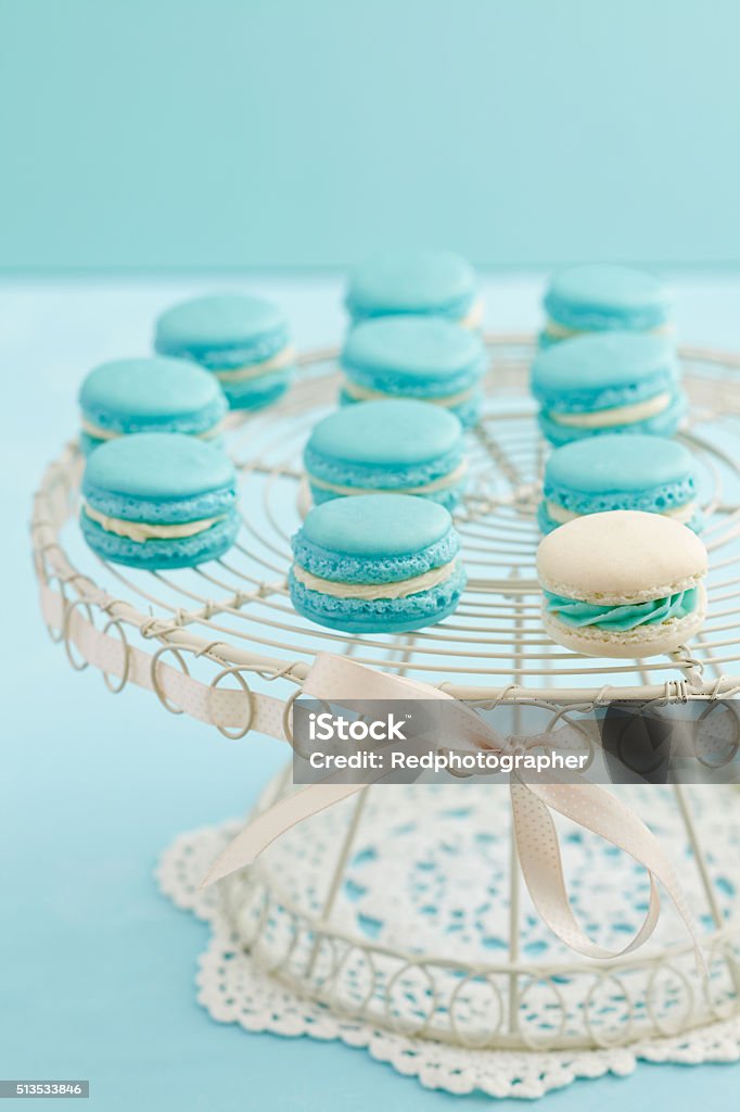 Macarons on cake stand Turquoise and white macarons with buttercream filling on a cake stand Almond Stock Photo