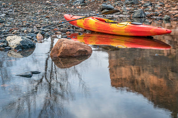 istock whitewater kayak on rocky shore 513533992