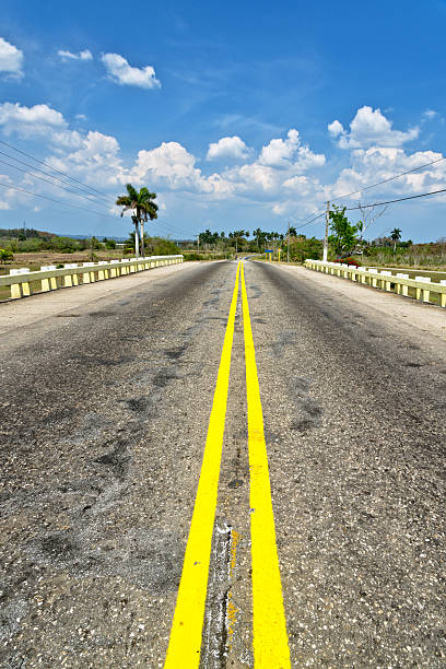 istock Country road in Cuba with fields and cloudy sky 513534500