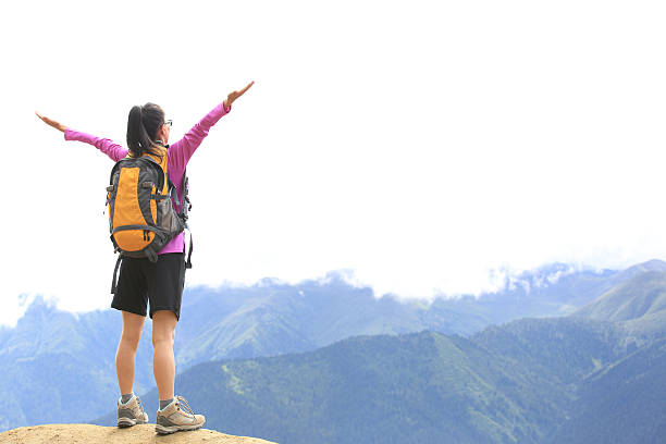 istock cheering hiking woman  mountain peak 513535431