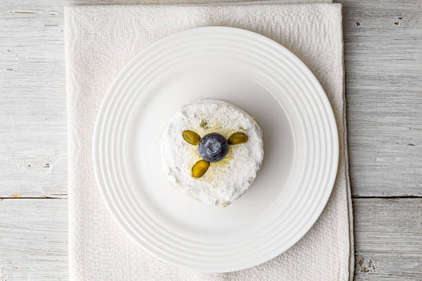 istock Cake with pistachio and blueberry on white wooden table 513535450