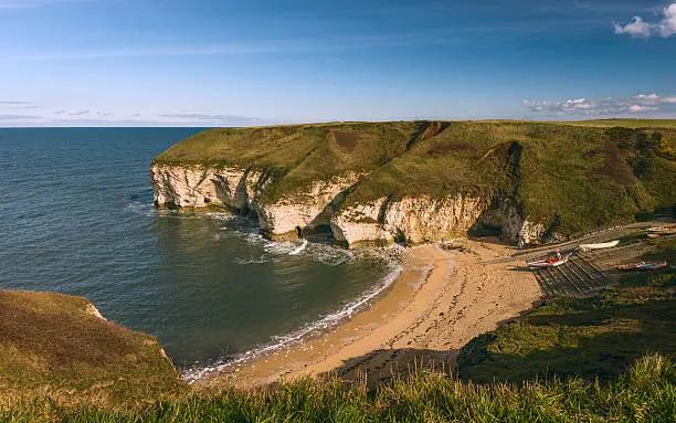 Flamborough, Yorkshire, UK. North Landing with view of sandy beach and high chalk cliffs, lifeboat and ramp on a fine sunny day near Flamborough, Yorkshire, UK.