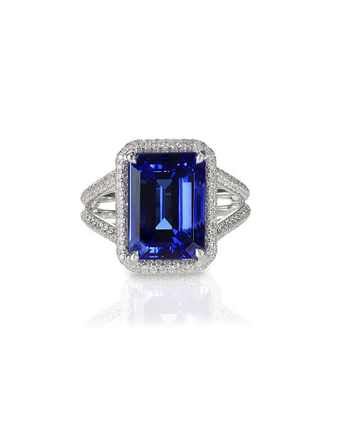 Large emerald cut sapphire engagement ring halo setting pave diamonds Large emerald cut sapphire  blue  engagement cocktail fashion ring with halo setting and pave diamonds isolated on white with a reflection saphire photos stock pictures, royalty-free photos & images