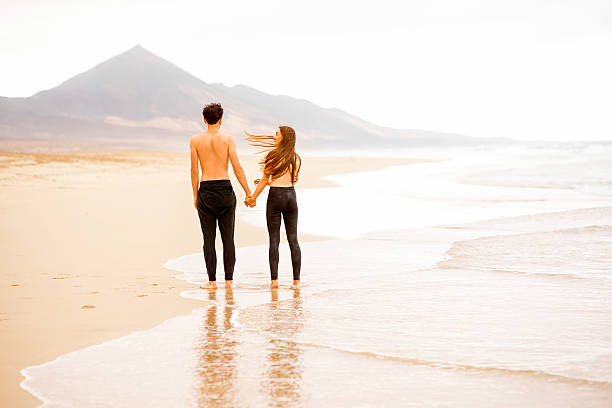 istock Couple with naked torso on the beach 513537372