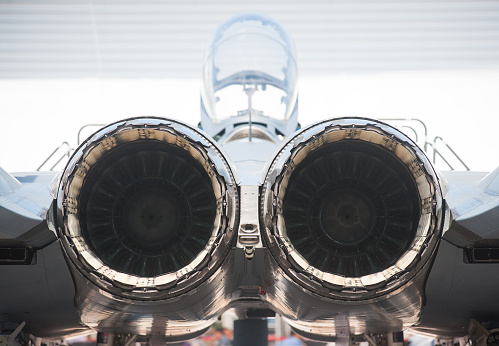 Rear view of twin engine, supersonic fighter jet.