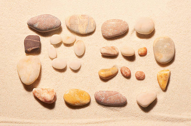 istock Airplane ticket from sea stones on sand. Summer beach background 513538702