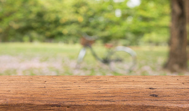 istock Wood table top on blur green abstract background 513538894