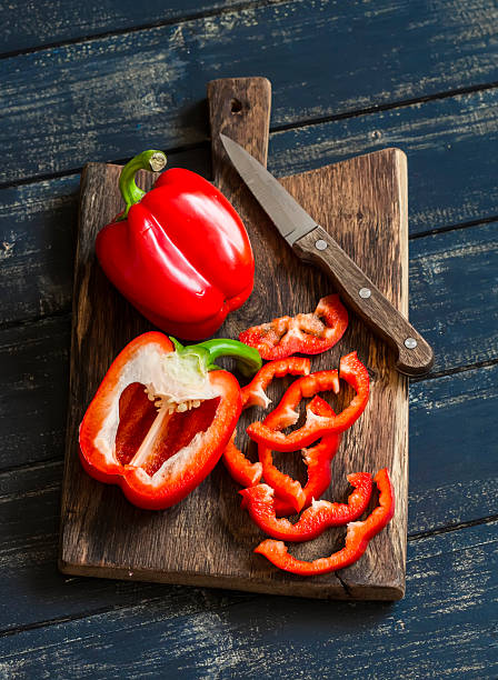 Fresh red sweet pepper on a wooden rustic board Fresh red sweet pepper on a wooden rustic board bell pepper stock pictures, royalty-free photos & images