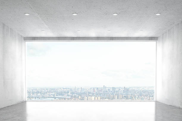 istock Empty concrete room with big window with city view 513541542
