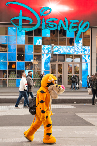 New York, USA -January 15, 2016: A street performer dressed like Tigger in Times Square outside the Disney store late in the day.