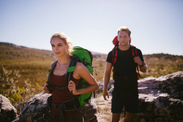 istock Fit couple hiking with backpacks exploring nature 513542402