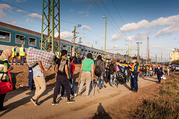 War refugees at the Gyekenyes Railway Station Zakany, Hungary - October 6, 2015: War refugees at Zakany Railway Station, Refugees are arriving constantly to Hungary on the way to Germany. 6 Octoberber 2015 in Zakany, Hungary. islamic state stock pictures, royalty-free photos & images