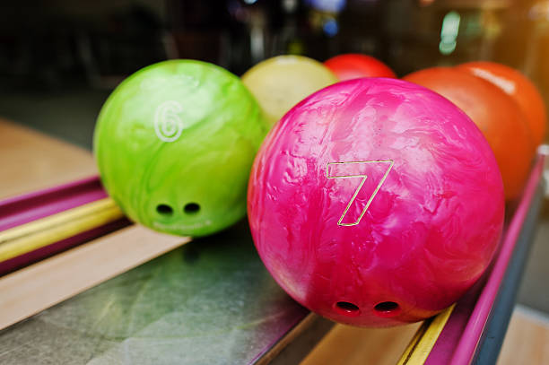 istock Two colored bowling balls of number 7 and 6. 513546448
