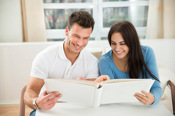 istock Young Couple Holding Green House Model 513548014