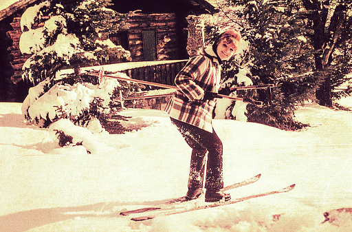Vintage photo of a young woman skiing.