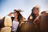 Hipster boho girl friends enjoys a summer road trip