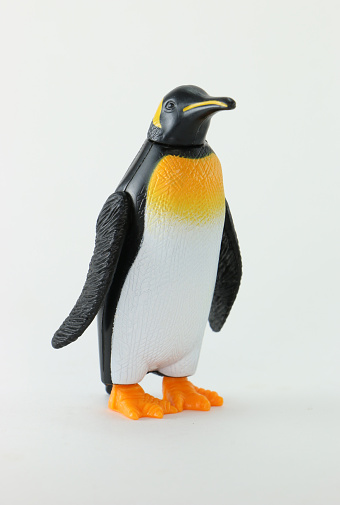 Penguin toy figurine on isolated white background