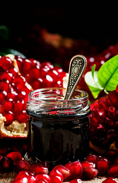 istock Homemade pomegranate jam in a glass jar with spoon 513549746