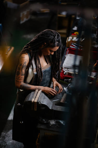 istock Skilled female bicycle mechanic assembling gears in her workshop 513552156