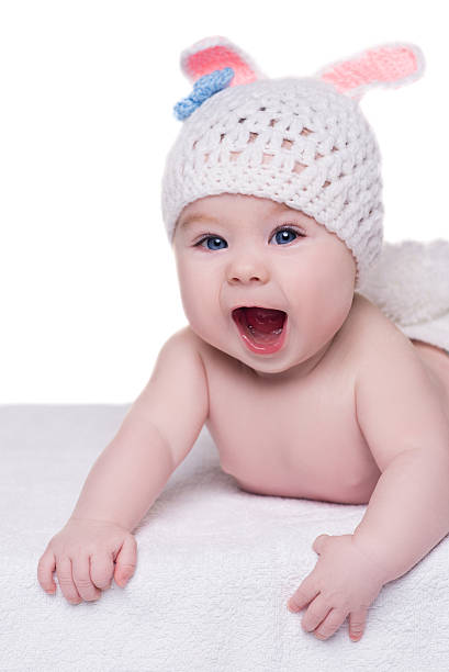 istock funny baby in white knitted hat with ears bunny crying 513555274