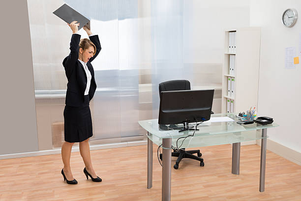 istock Angry Businesswoman Throwing Laptop 513555814