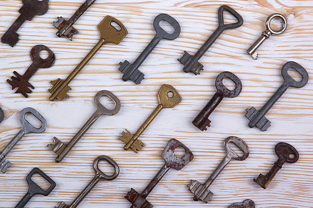 istock Old keys on wooden background 513556272