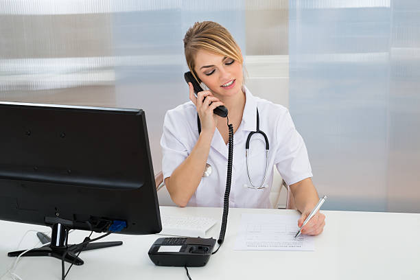 istock Young Female Doctor Talking On Telephone 513556974