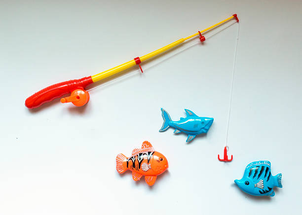 istock Fishing rod and fish from plastic on white background 513557510