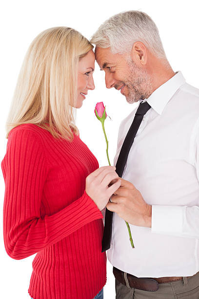 istock Romantic mature couple holding rose 513565759
