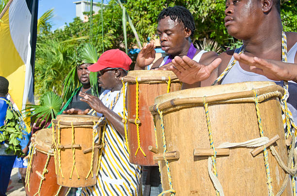 Hopkins Village, Belize, - November 19, 2013: The annual Garifuna Settlement day celebrations in full flow. A procssession of singers, dancers, and drummers make their way along the main road in the village of Hopkins in the Stann Creek District of Belize.
