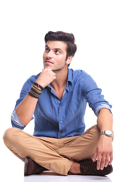 istock smiling man thinking and looking up to his side 513567343