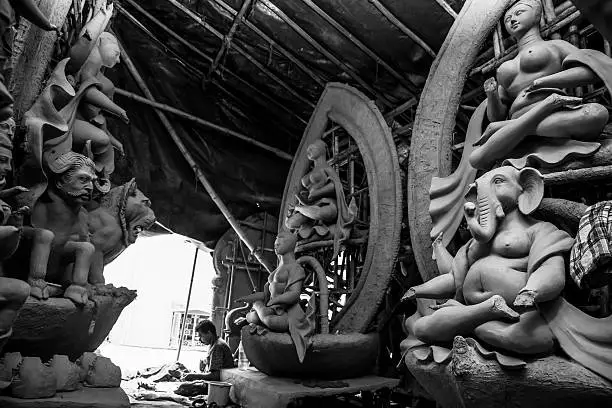 Indian deity - Goddess Durga idols being prepared by artisans for the festival Durga Puja. Artisans from West Bengal-India come to Delhi every year to make these idols for the Durga Puja Festival in Delhi. Its a 5 day long festival which ends with the immersion of these idols in the river.