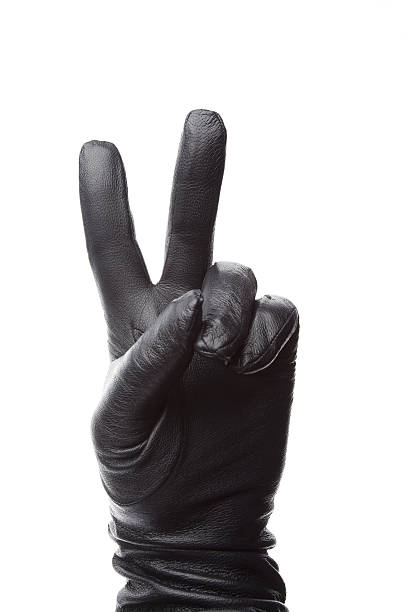 istock Hand in black leather gloves showes victory 513568137