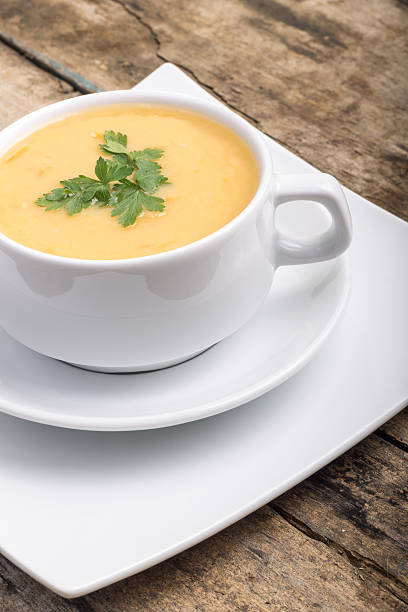istock Pea soup on wood weathered background 513568529