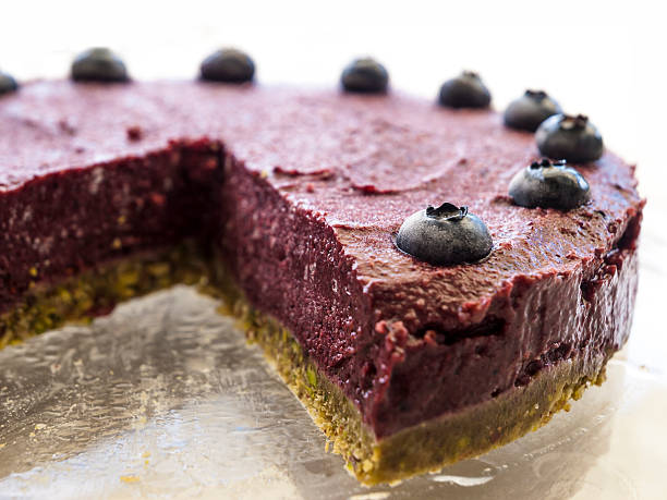 Raw vegan blueberry pistachio cake stock photo