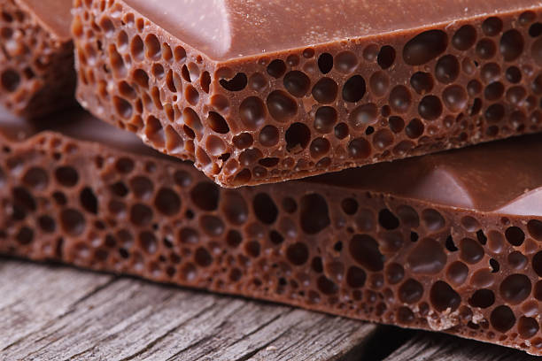 istock Aerated milk chocolate on old wooden table macro 513570025