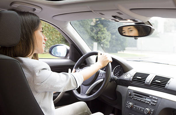 istock Happy girl driving a car 513570355