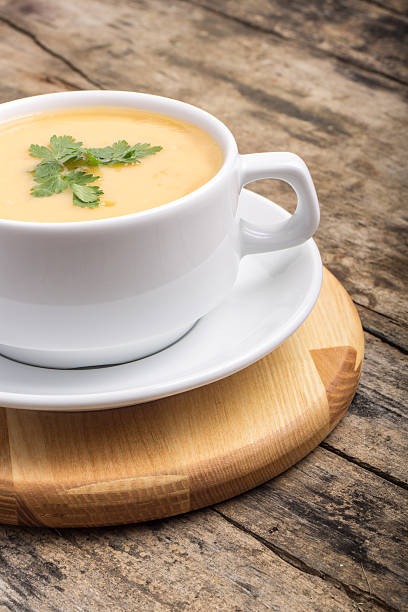 istock Pea soup on wood weathered background 513570467