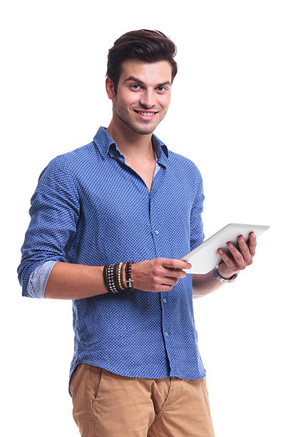 istock young smiling casual man holding a pad tablet 513571515