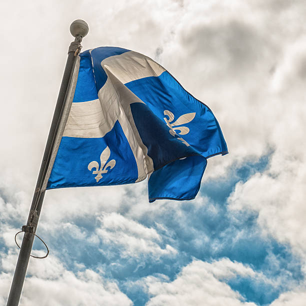istock quebec flag waving on the sky 513571873