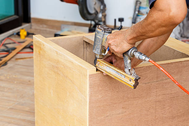 istock carpenter use air-gun for make new furniture 513571945