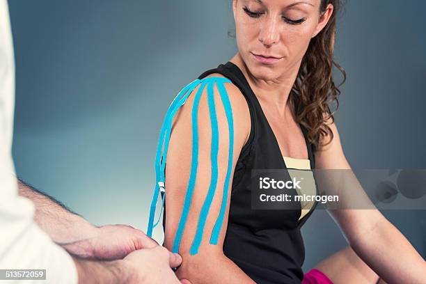 Treating Shoulder With Kinesio Tape Stock Photo - Download Image Now - Adhesive Tape, Adult, Adults Only