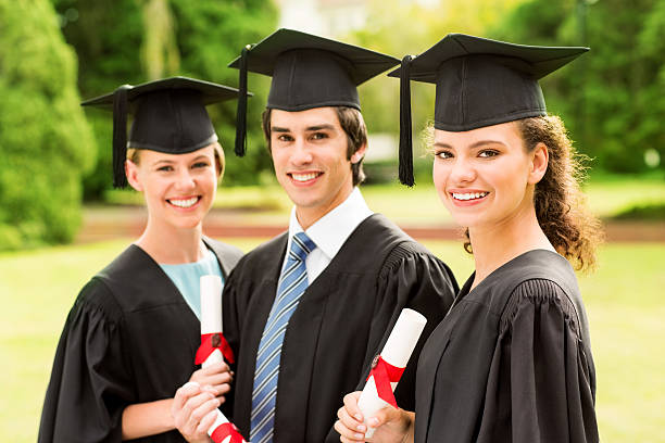 istock Students Holding Diplomas On Graduation Day At College Campus 513572329
