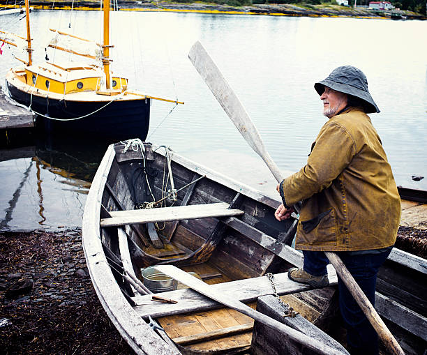 istock Fisherman Standing in a Dory, Mahone Bay, Nova Scotia 513572453
