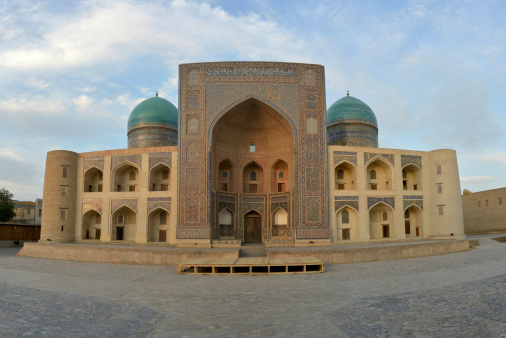 Mir-i Arab medrese (Bukhara,  Uzbekistan) is situated against the blue sky.